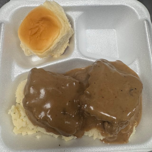 Hamburger Steak Under Garlic Mashed Potatoes Entree.